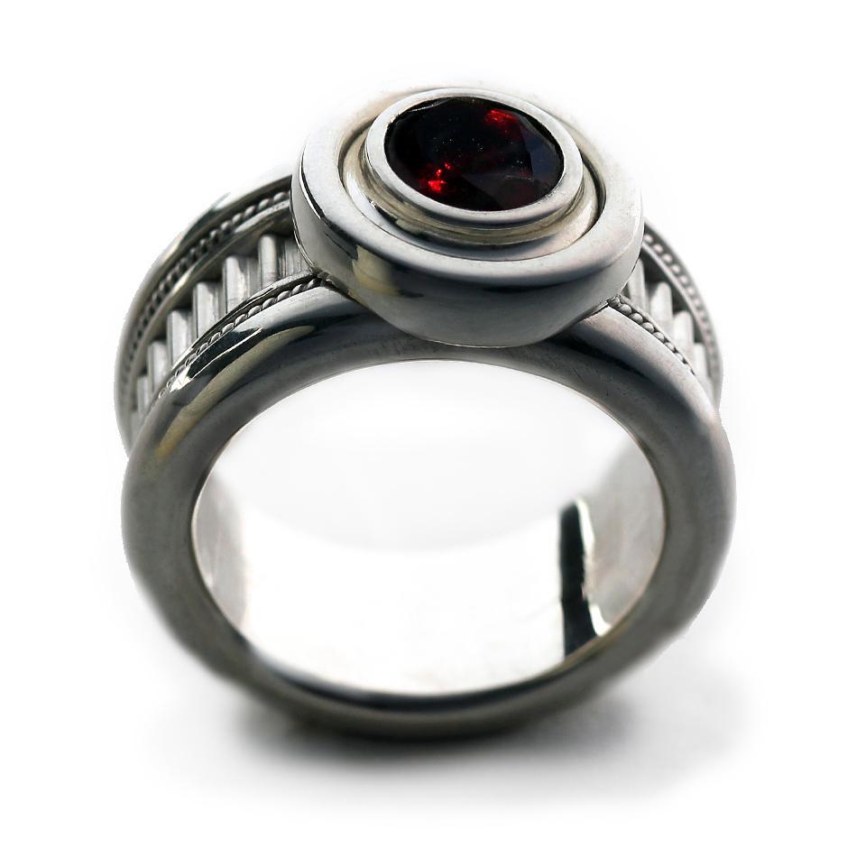 Man's silver misti wedding band with garnet