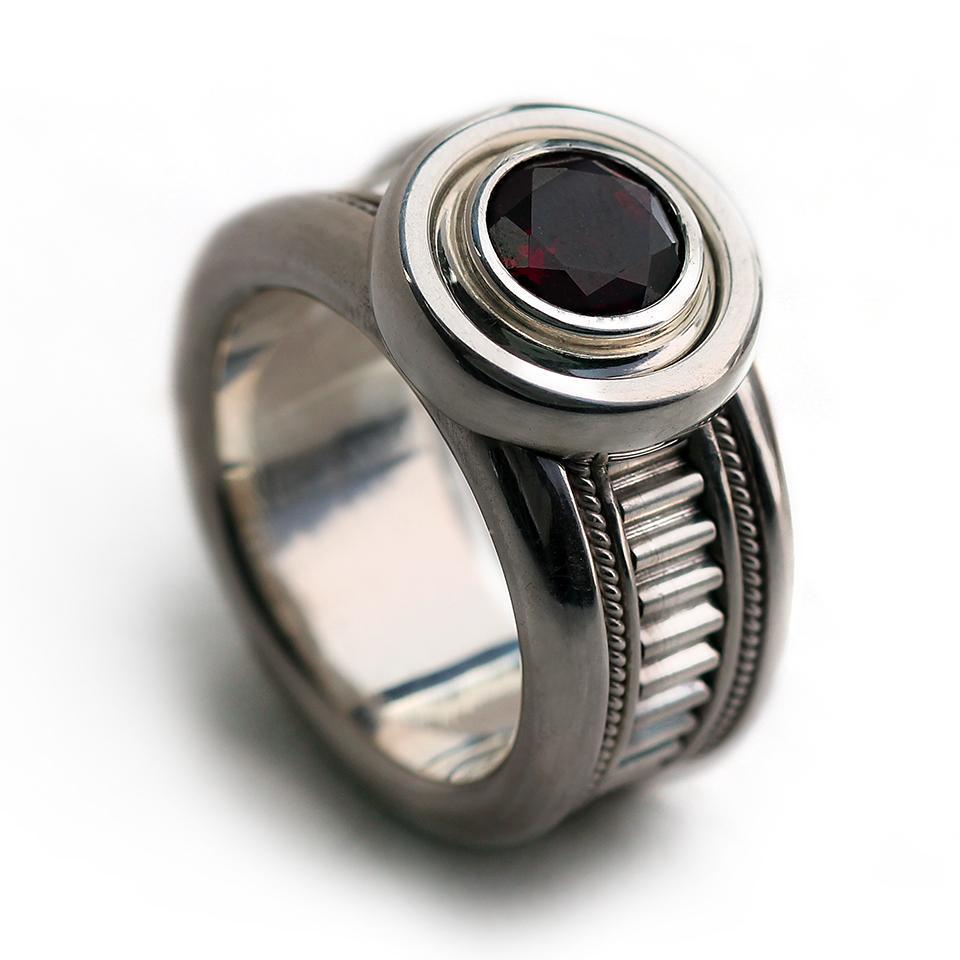 Man's silver misti wedding band with garnet