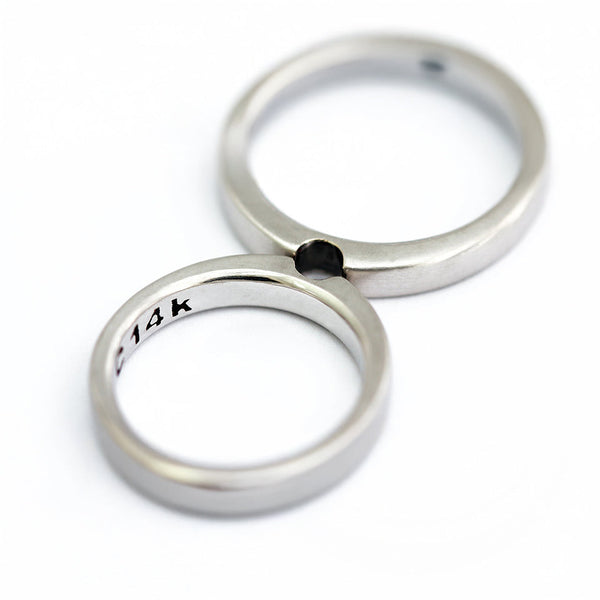 Infinity shape: handcrafted Cadi couples' set, two interlocking 18k silver bands with a black stone, wedding rings.