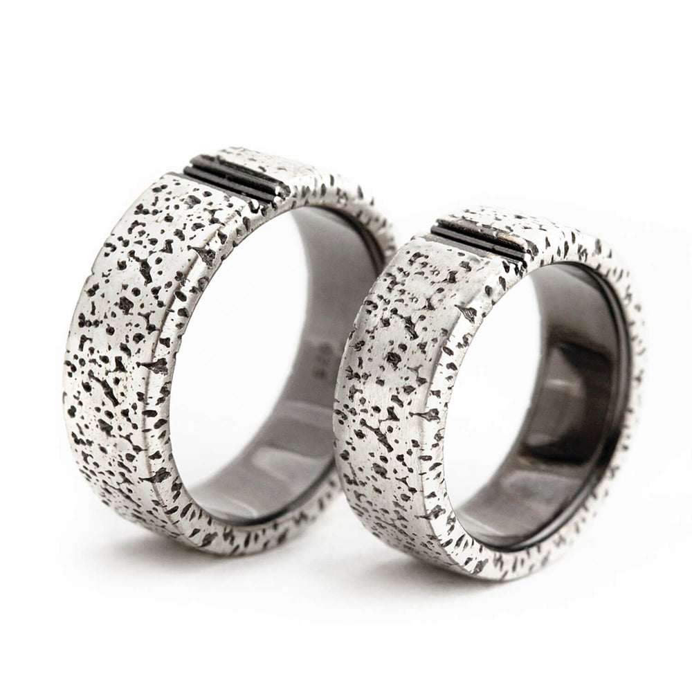 Cadi custom sun rings with dark engraved rays completing when the matching bands meet