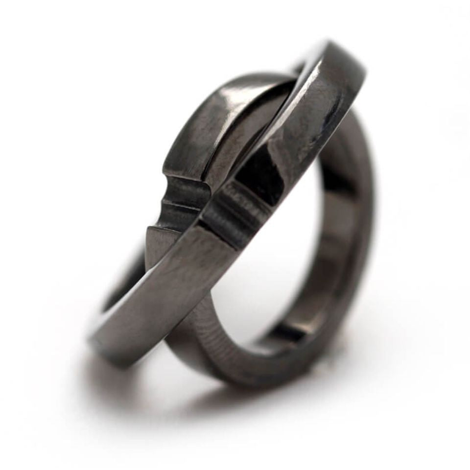 Cadi black rhodium wedding rings joined to reveal a hidden heart between the bands
