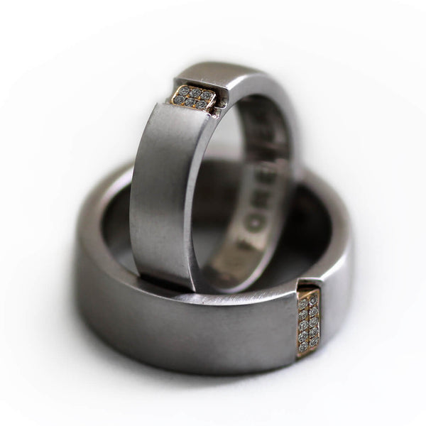 Detail of the matte silver bands, yellow gold diamond settings, and contrasting ring widths