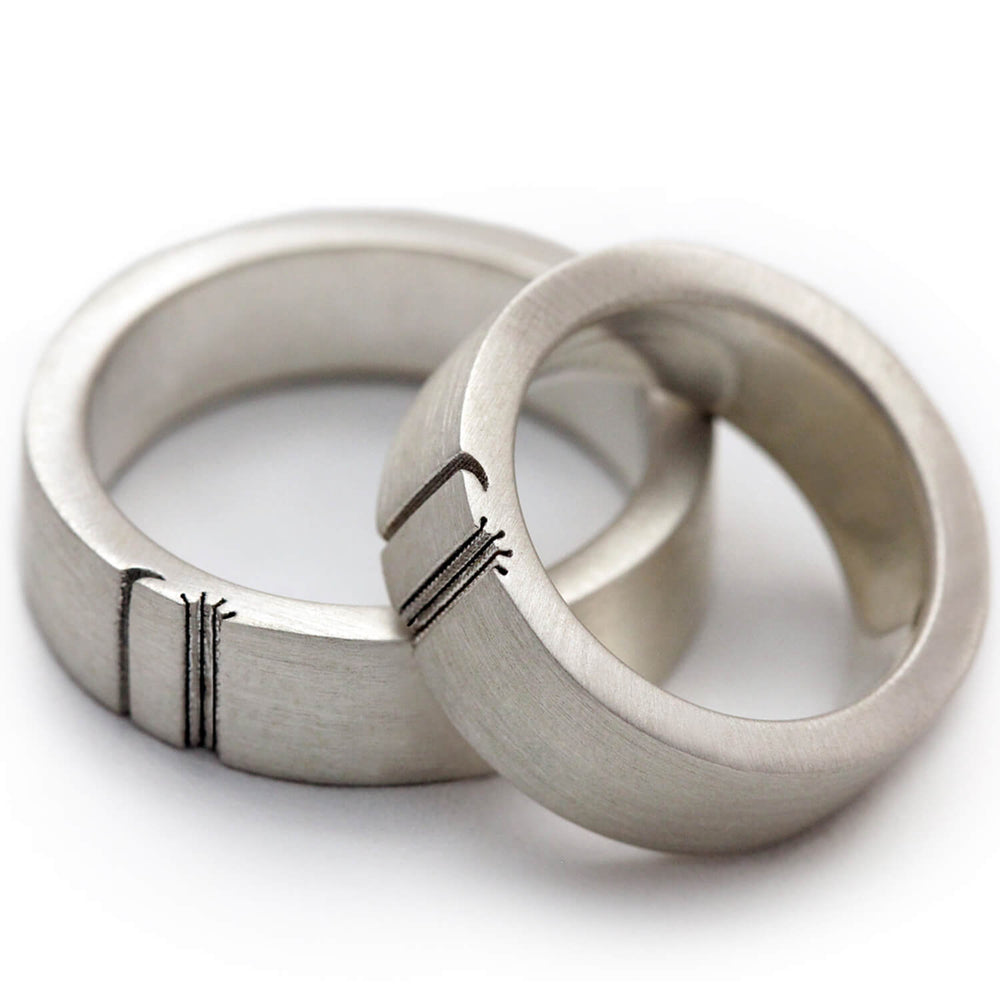 Cadi sun and moon matching rings aligned to complete a hand-engraved celestial symbol