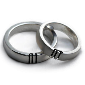 Detail of the engraved letter halves aligned across the two polished rings