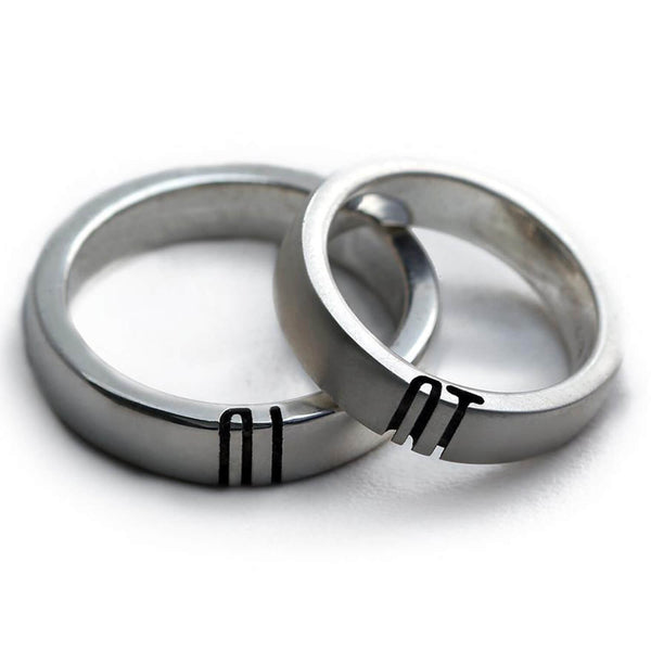 Detail of the engraved letter halves aligned across the two polished rings