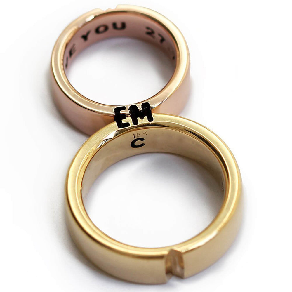 Cadi bold mixed-metal wedding bands joined to reveal custom letters and a hidden heart