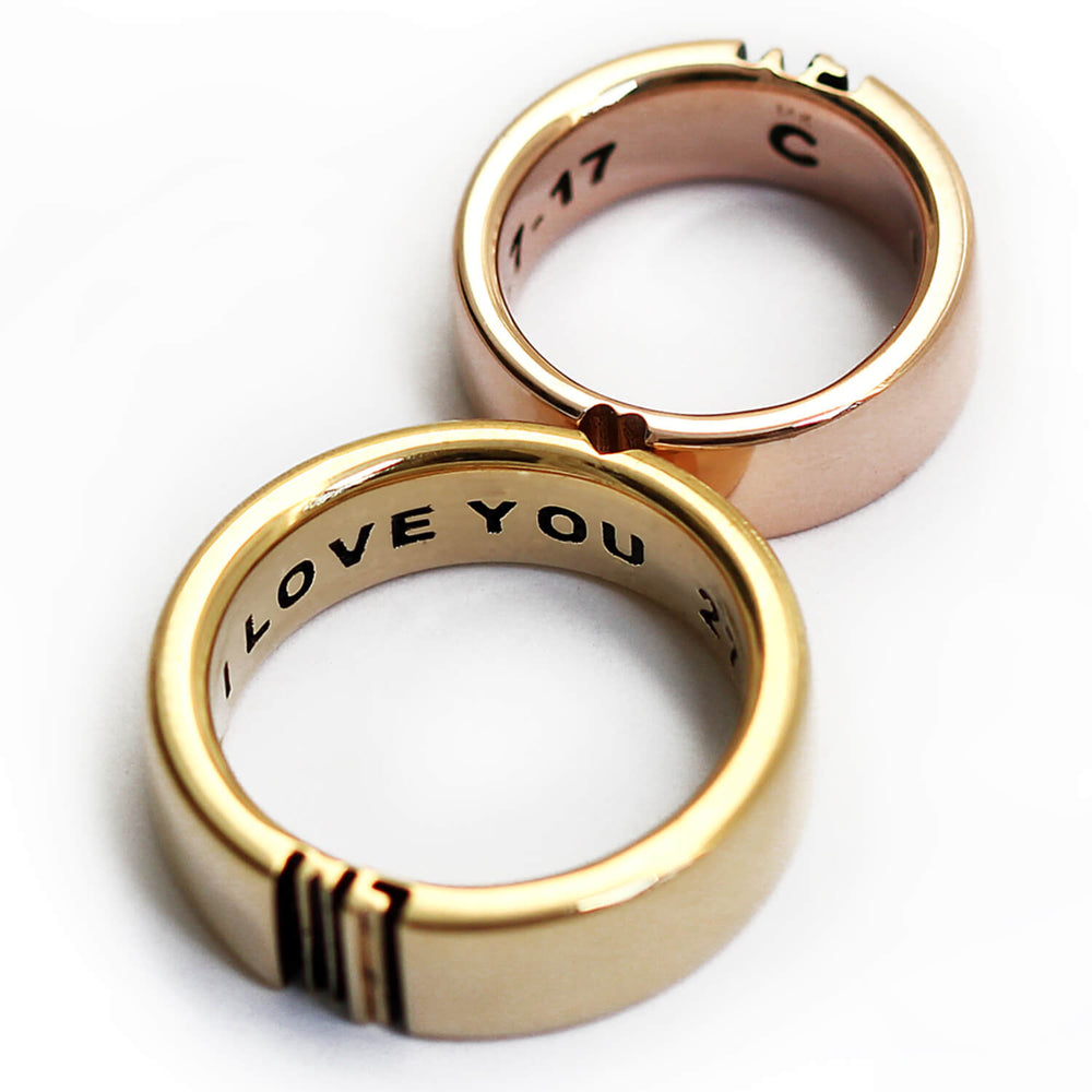 Cadi bold mixed-metal wedding bands joined to reveal custom letters and a hidden heart