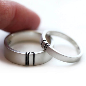 Detail of the custom letter halves aligned between the wide and narrow rings