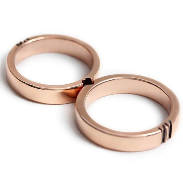 Detail of the engraved initials and heart design spanning the two matching promise rings