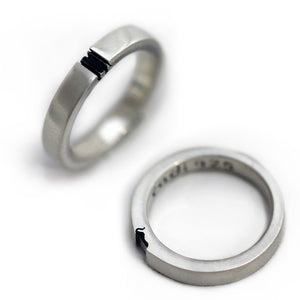 Two silver rings with black accents on a white background
