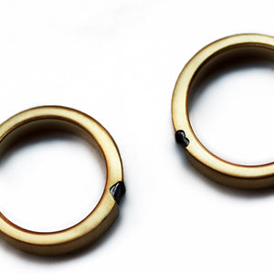 Custom handmade wedding rings with hidden black diamond hearts forming symbol when united, 18K gold matching bands Barcelona artisan jewelry