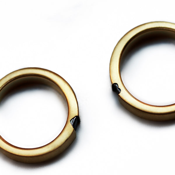 Custom handmade wedding rings with hidden black diamond hearts forming symbol when united, 18K gold matching bands Barcelona artisan jewelry