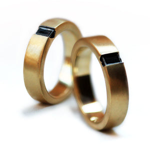 Black diamond wedding ring set artisan crafted gold bands with brushed texture, bespoke couple rings handmade Barcelona atelier, conflict free gemstones