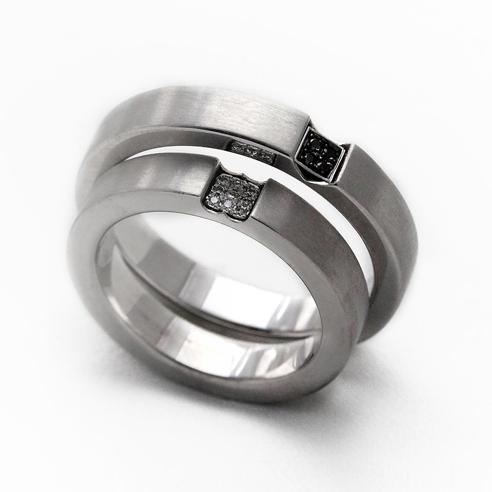 Cadi diamond promise ring set with black and white stones forming a hidden heart