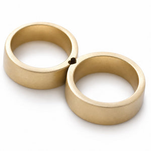 Cadi matching gold rings placed together, showing the  heart-shaped connection between the two bands