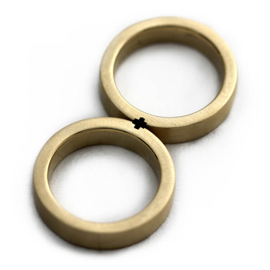 Cadi matte matching rings joined to form a minimalist hidden plus symbol