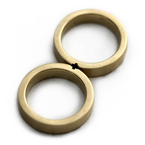 Cadi matte matching rings joined to form a minimalist hidden plus symbol