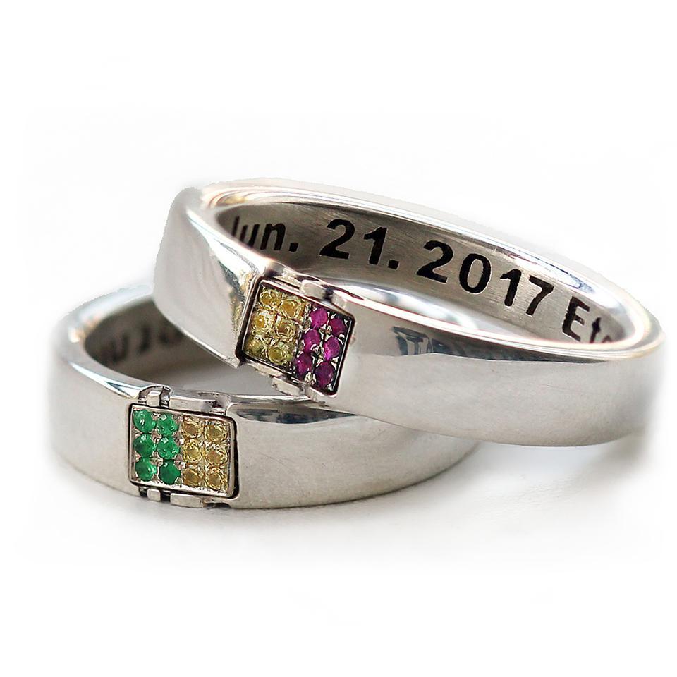 Cadi custom matching rings with sapphire, emerald, and ruby initials across the bands