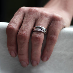 and wearing silver diamond engagement and wedding ring