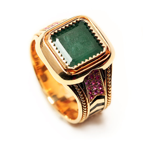 Luxury handcrafted yellow gold emerald statement ring with ruby pavé side details, decorative filigree engraving and geometric black hot enamel chevron band