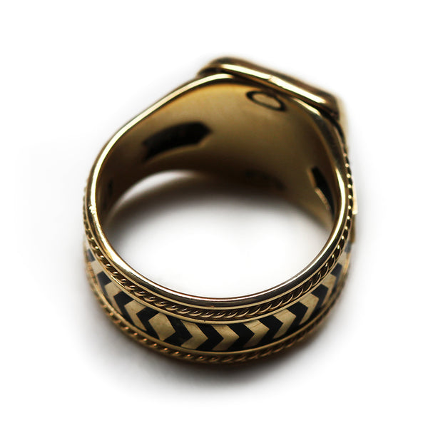 Interior and band detail of handcrafted yellow gold statement ring featuring black hot enamel chevron inlay, filigree engraved edges and seamless construction showing clean professional finish with no visible solder joints or connections