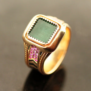 Vintage style yellow gold emerald and ruby statement ring with square emerald centerpiece, handcrafted filigree detailing and black hot enamel chevron texture band