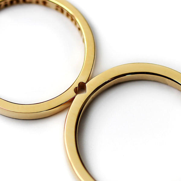 Yellow gold hidden heart couple rings aligned forming heart shape, minimalist matching wedding bands
