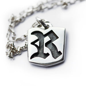 Personalized gothic initial pendant in sterling silver with Old English letter cutout design shown with matching chain
