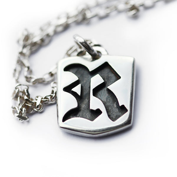 Personalized gothic initial pendant in sterling silver with Old English letter cutout design shown with matching chain
