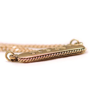 18k Gold necklace with a detailed filigran on its contour on a white background