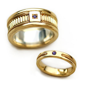 Handcrafted his and hers yellow gold wedding ring set with vintage fluted texture, decorative filigree edges and purple sapphire accent stone