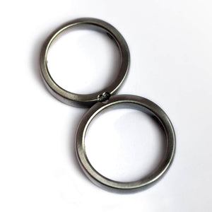 Detail of the classic white diamond settings and reflective finish across both bands