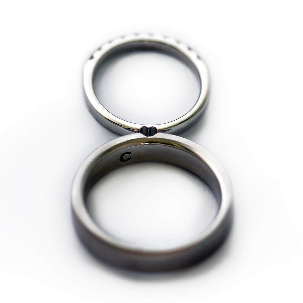 Cadi matching promise ring set with a wide band and diamond eternity band forming a hidden heart