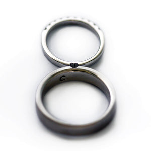 Cadi matching promise ring set with a wide band and diamond eternity band forming a hidden heart