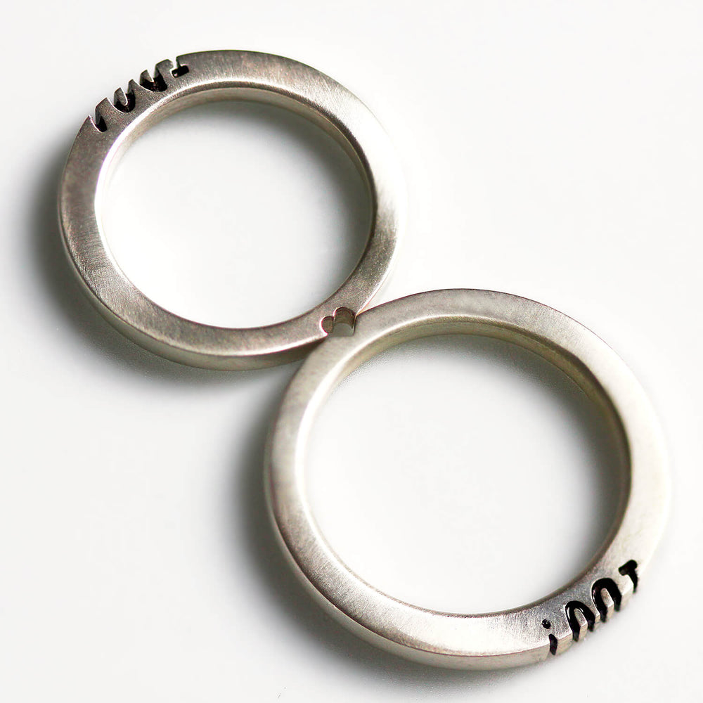 Cadi "I Do" wedding ring set with the engraved phrase divided across two narrow bands