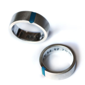 Brushed silver matching wedding bands with light blue enamel stripe and hidden heart negative space couple rings.