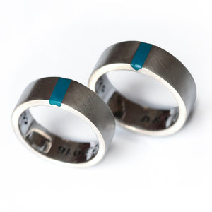 Matching couple wedding bands in נrushed silver  bands with light blue enamel stripe and hidden and concealed heart connection design couple rings. 