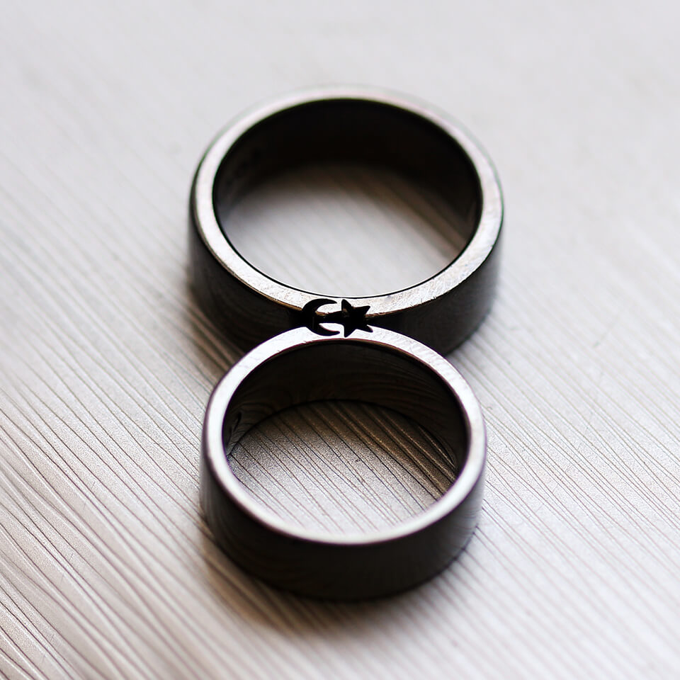 Cadi black rhodium moon and star ring set joined to complete the celestial symbols