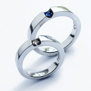 White gold wedding band set with hidden heart gemstones moonstone sapphire, personalized engraving inside matching rings, artisan crafted Barcelona