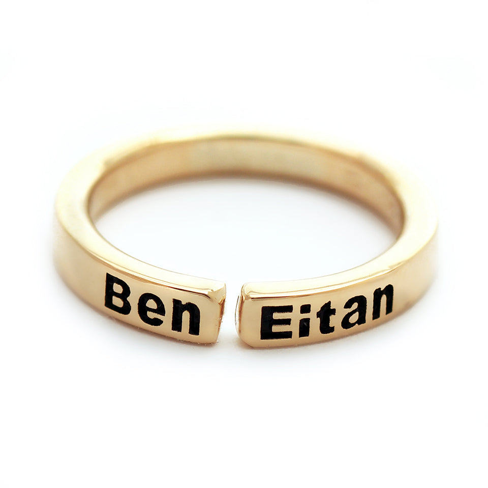 Custom name mother ring in solid 18K yellow gold open band showing engraved children’s names with blackened lettering and minimalist modern design