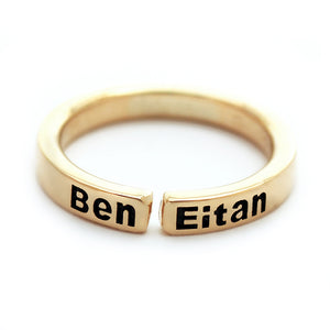 Custom name mother ring in solid 18K yellow gold open band showing engraved children’s names with blackened lettering and minimalist modern design