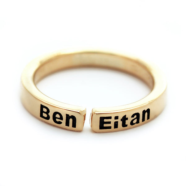 Custom name mother ring in solid 18K yellow gold open band showing engraved children’s names with blackened lettering and minimalist modern design