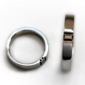 Minimalist white gold couple ring set displayed individually, emphasizing the sleek polished finish and discreet paw print connection detail without black rhodium coating.