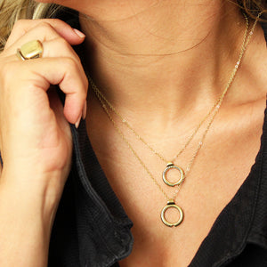 Layered couples necklace worn on neck featuring two interlocking yellow gold circle pendants designed to form a heart when brought together, engraved with romantic message and symbolic matching jewelry design