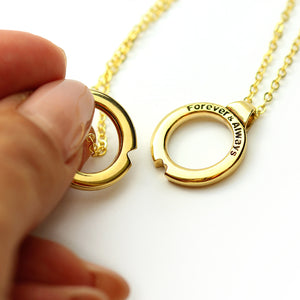 Interlocking couples pendant necklace in solid yellow gold with removable circle charms forming a heart when brought together, designed for partners to share