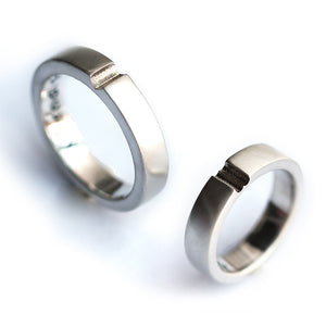 Minimalist silver couple rings set with hidden heart connection design, modern matching promise rings for couples
