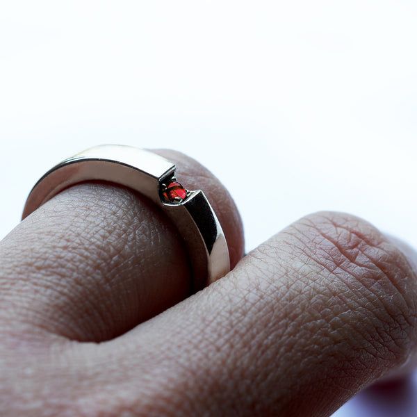 Red ruby wedding band with heart shaped gemstone detail, polished white gold couple ring worn on hand, custom engagement rings Barcelona