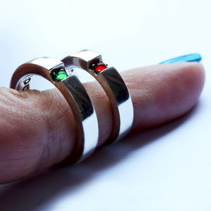 Matching couple wedding rings ruby and tsavorite hearts, his and hers bands polished finish worn on fingers, handcrafted Barcelona jewelry red green gemstones