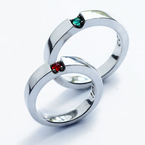 White gold wedding band set with hidden heart gemstones ruby tsavorite, personalized engraving inside matching rings, artisan crafted Barcelona rare garnet
