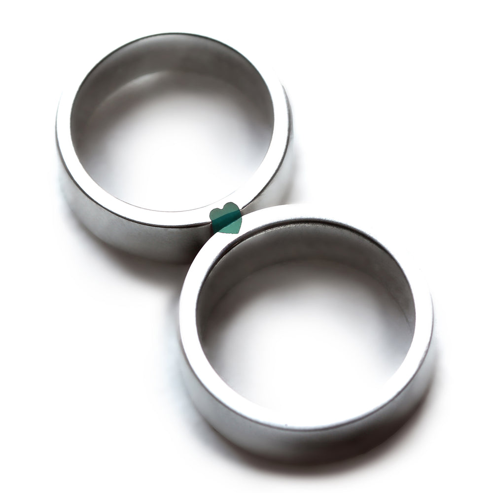 Matching silver wedding bands with turquoise enamel inlay, hidden heart negative space couple rings.